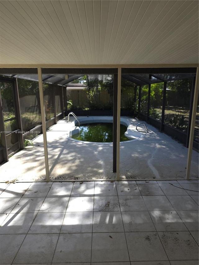 view of patio with a swimming pool with hot tub