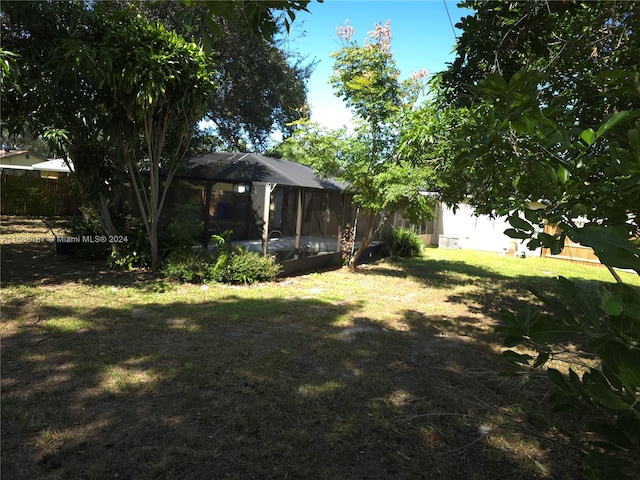 view of yard with a sunroom