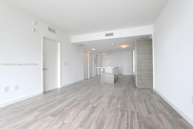 unfurnished living room featuring light wood-type flooring