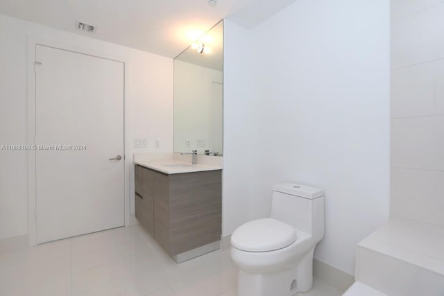 bathroom with vanity, tile patterned floors, and toilet