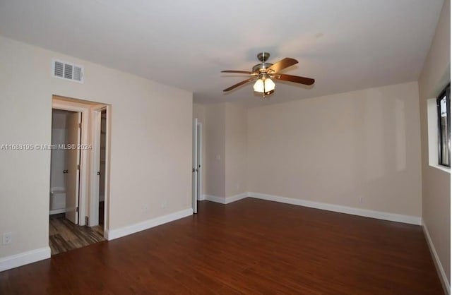 spare room with dark wood-type flooring and ceiling fan