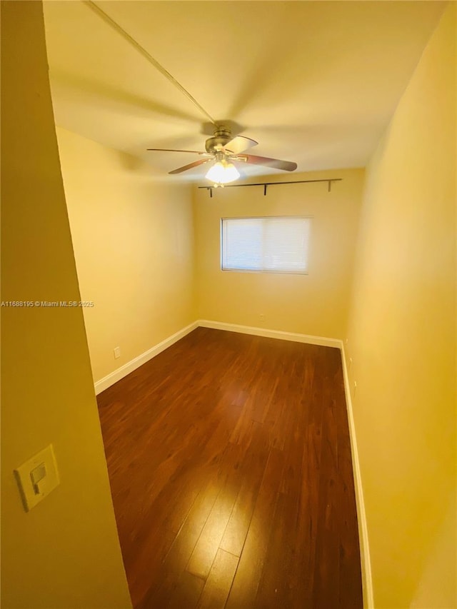 spare room featuring dark hardwood / wood-style floors and ceiling fan