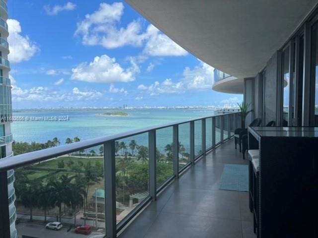 balcony featuring a water view