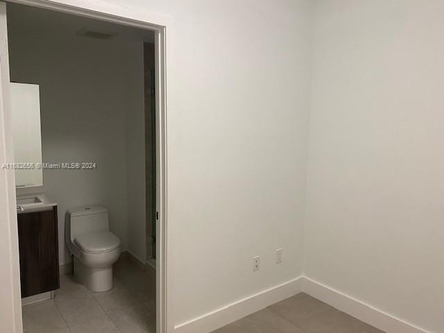 bathroom with vanity, tile patterned floors, and toilet