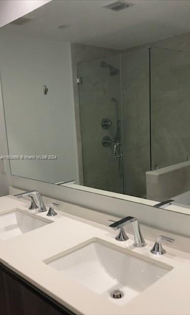 bathroom featuring walk in shower and vanity