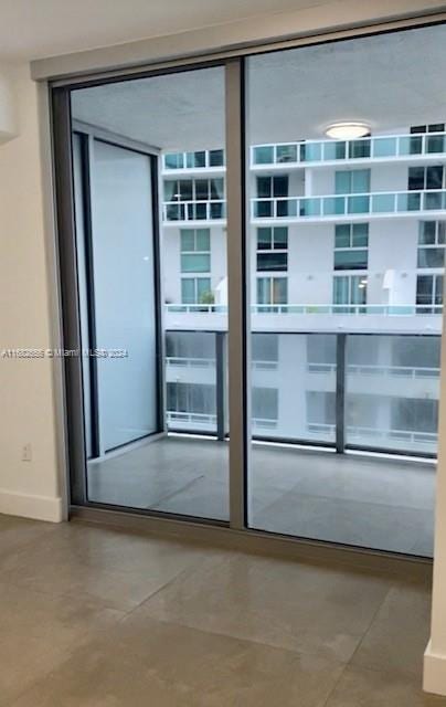 doorway to outside with concrete floors