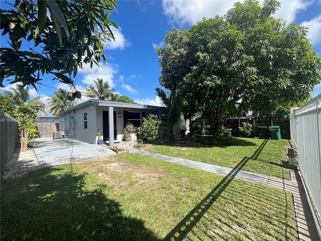 view of yard featuring a patio and central AC