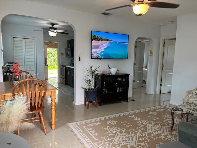 tiled living room featuring ceiling fan