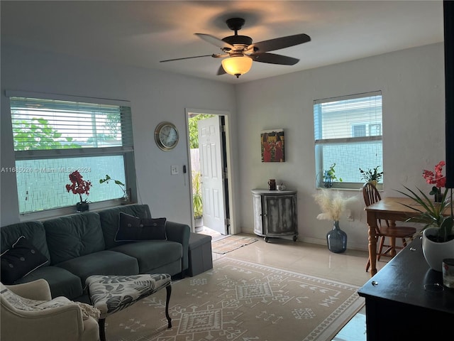 living room with ceiling fan and light tile patterned flooring