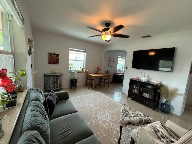 living room with ceiling fan and light tile patterned flooring