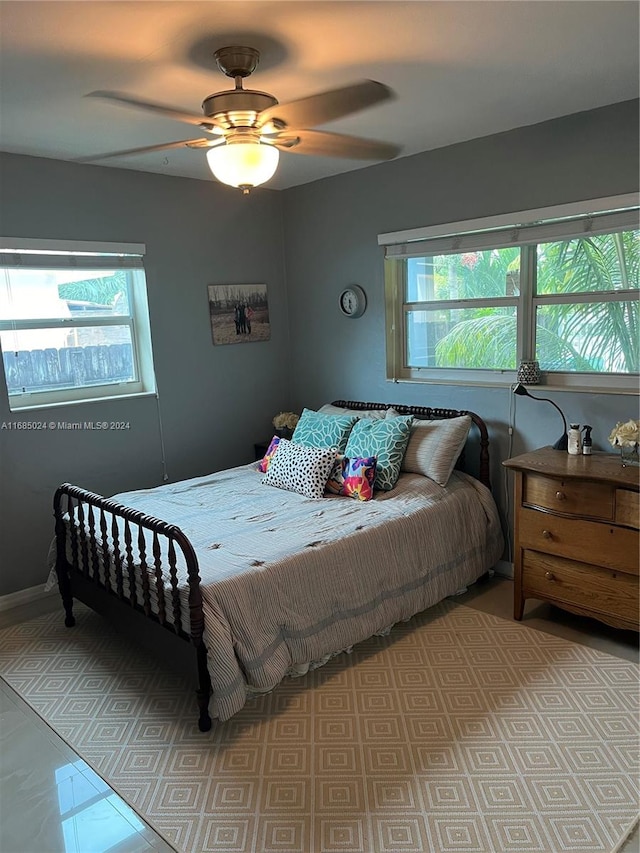 bedroom with multiple windows and ceiling fan