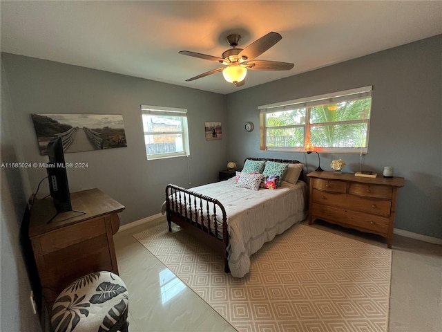 bedroom with multiple windows and ceiling fan