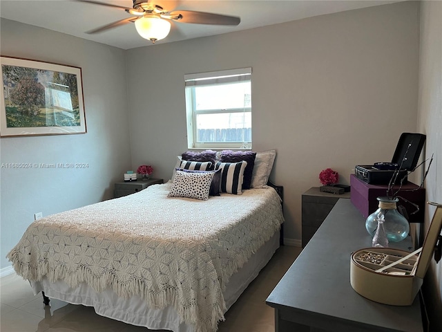 tiled bedroom featuring ceiling fan