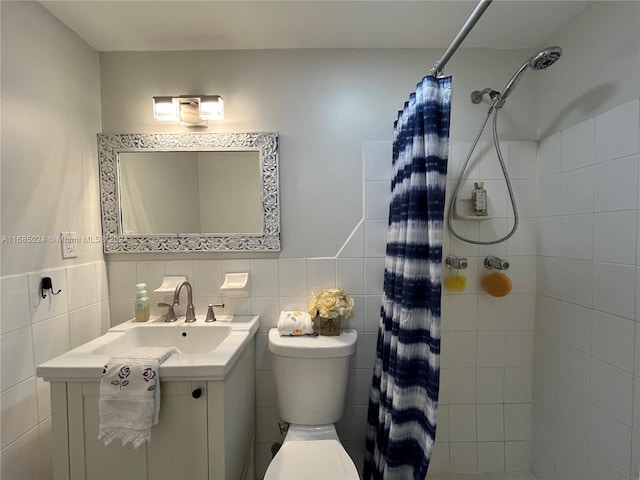 bathroom with a shower with curtain, vanity, tile walls, and toilet