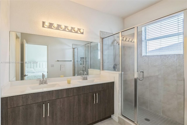 bathroom featuring an enclosed shower, vanity, and tile patterned floors