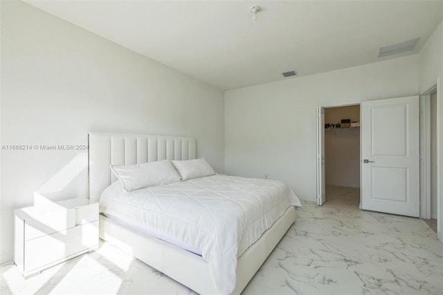 bedroom featuring a closet and a walk in closet