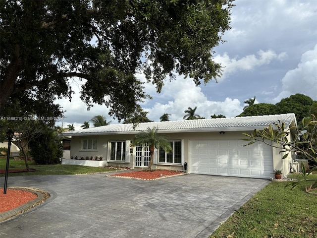 ranch-style house with a front yard and a garage