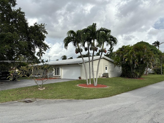 ranch-style house with a garage and a front yard