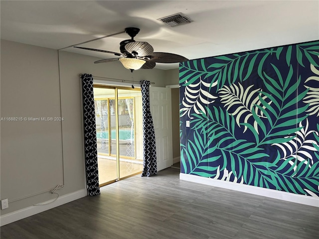 spare room with wood-type flooring and ceiling fan