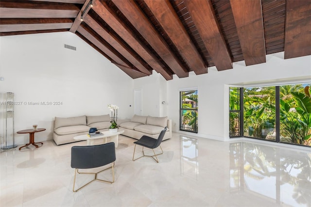 living room with high vaulted ceiling and beamed ceiling