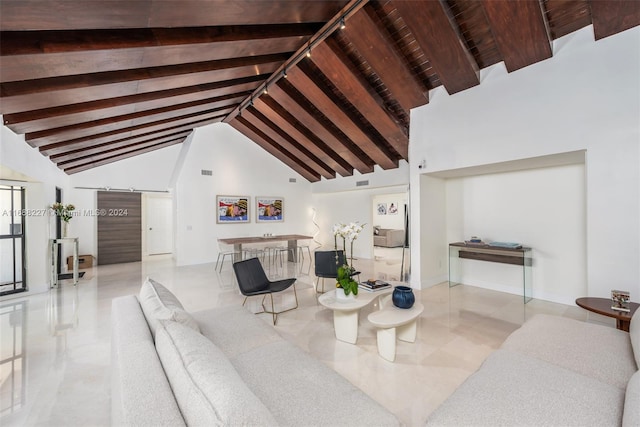 living room with a barn door, beam ceiling, high vaulted ceiling, and rail lighting