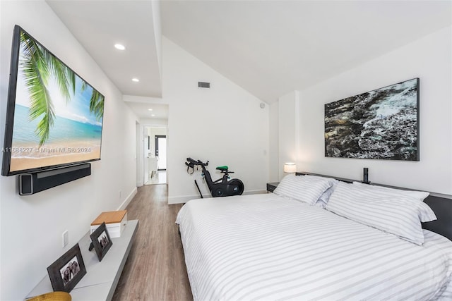 bedroom featuring hardwood / wood-style floors and high vaulted ceiling