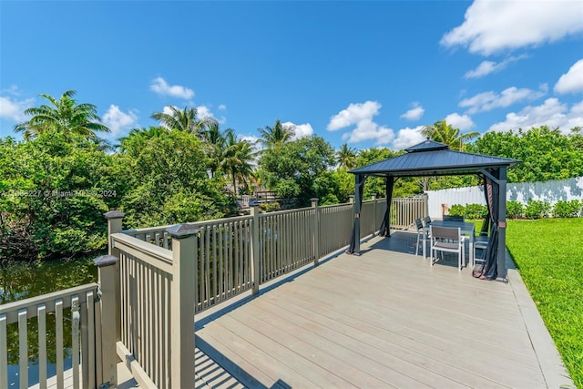 wooden deck featuring a gazebo and a water view