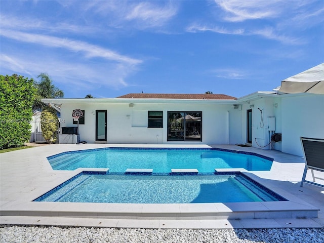 view of swimming pool featuring an in ground hot tub and a patio