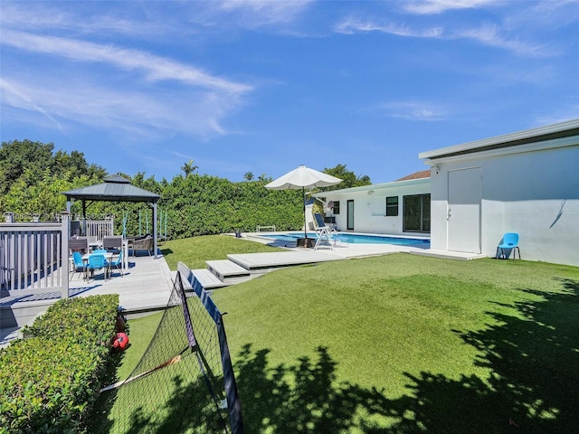 view of yard featuring a gazebo and a swimming pool side deck