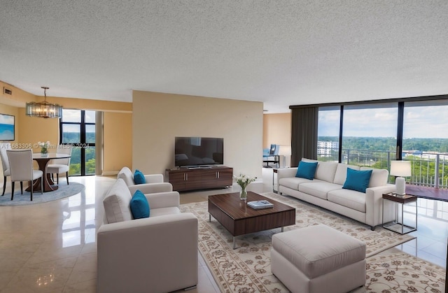 tiled living room with a wealth of natural light, a notable chandelier, and a textured ceiling