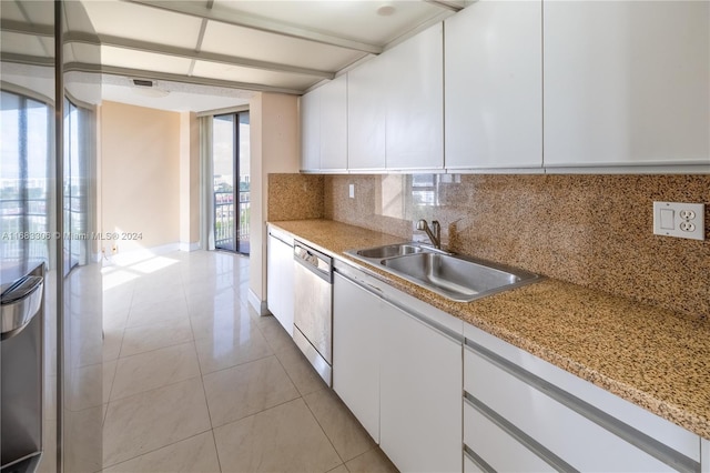 kitchen featuring white cabinetry, a healthy amount of sunlight, and dishwasher