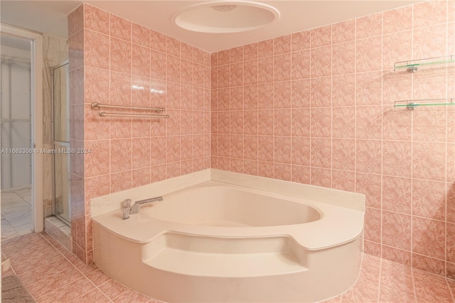 bathroom featuring tile walls, tile patterned floors, and separate shower and tub