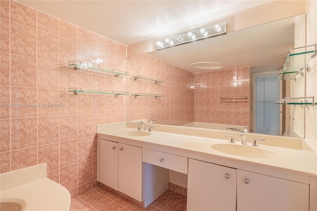 bathroom with vanity, tile patterned floors, and tile walls