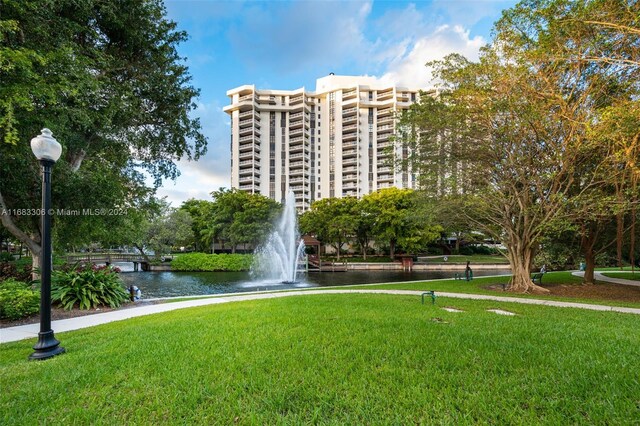 exterior space featuring a lawn and a water view