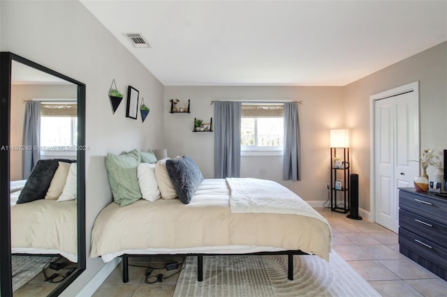 tiled bedroom with a closet