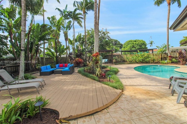 view of pool with outdoor lounge area, a patio area, and a deck