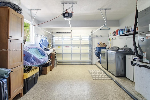 garage with washing machine and dryer and a garage door opener