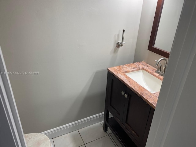 bathroom featuring tile patterned flooring, vanity, and toilet