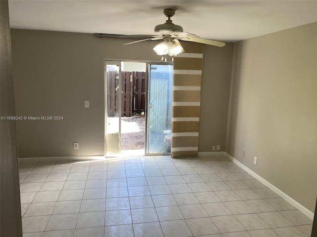 tiled spare room featuring ceiling fan