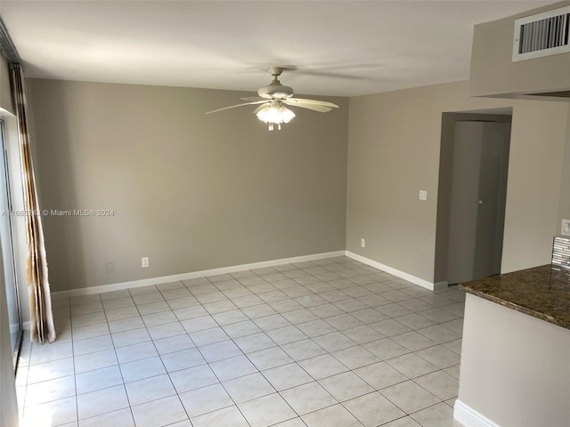 empty room with light tile patterned floors and ceiling fan