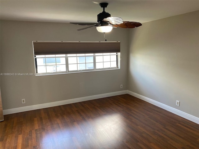 unfurnished room with dark hardwood / wood-style flooring, a wealth of natural light, and ceiling fan