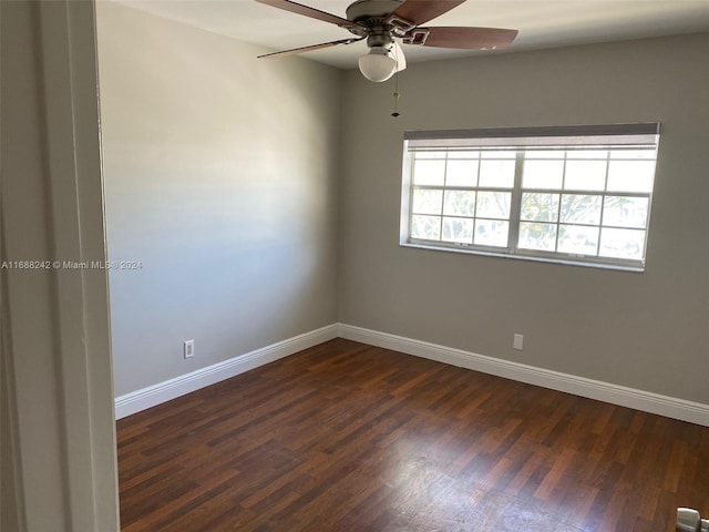 spare room featuring dark hardwood / wood-style flooring and ceiling fan