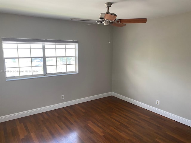 unfurnished room with dark hardwood / wood-style flooring and ceiling fan