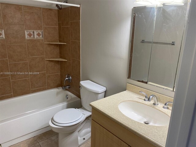 full bathroom featuring tile patterned floors, vanity, toilet, and tiled shower / bath