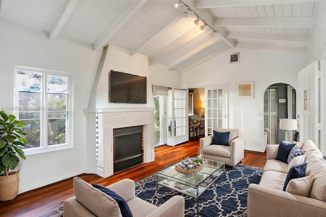 living room with a fireplace, wood-type flooring, lofted ceiling with beams, and wood ceiling