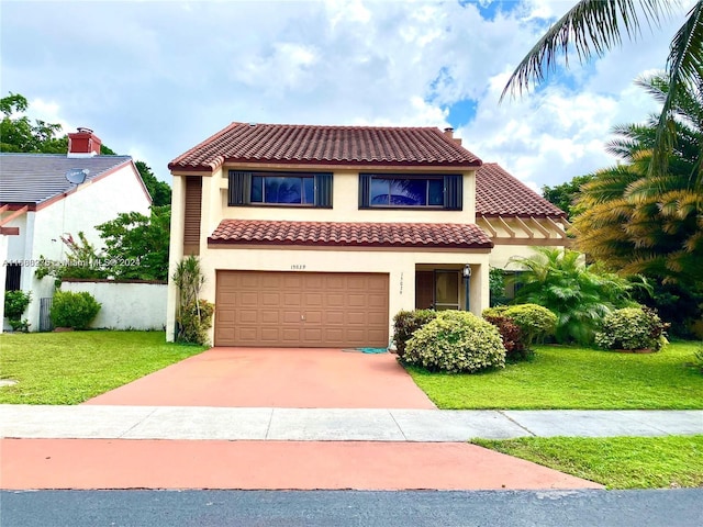 mediterranean / spanish home featuring a front lawn and a garage