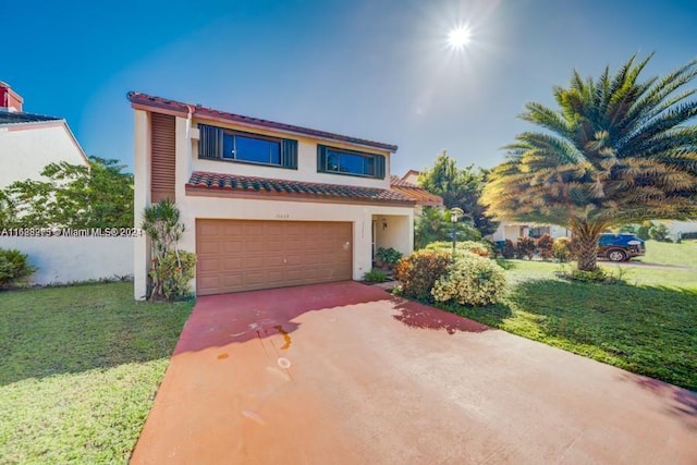 mediterranean / spanish home with a front yard and a garage