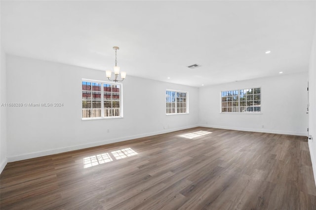 361 E 39th St, Hialeah, FL 33013 - unfurnished room featuring a chandelier, wood finished floors, and recessed lighting