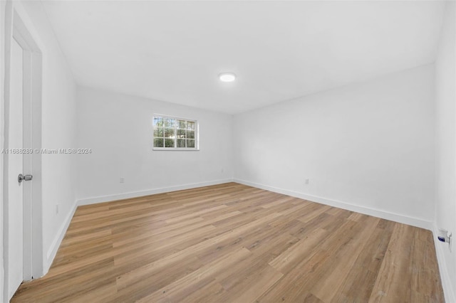 unfurnished room with light wood-type flooring