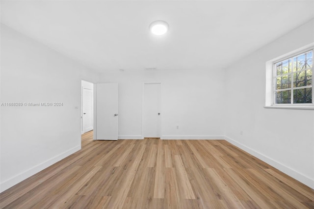 361 E 39th St, Hialeah, FL 33013 - unfurnished room with baseboards and light wood-style flooring